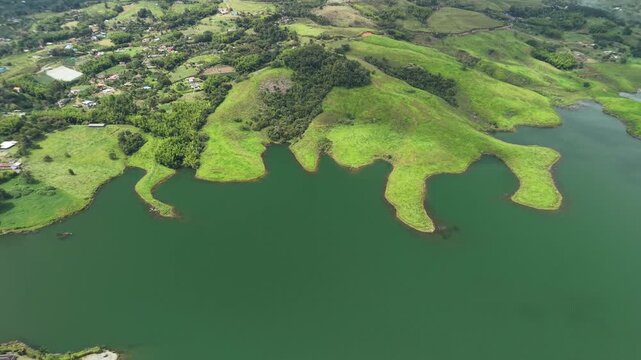 Aerial view of green hills surrounding Calima Lake