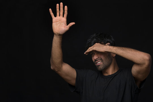 man with seasonal disorder blocking light with hands