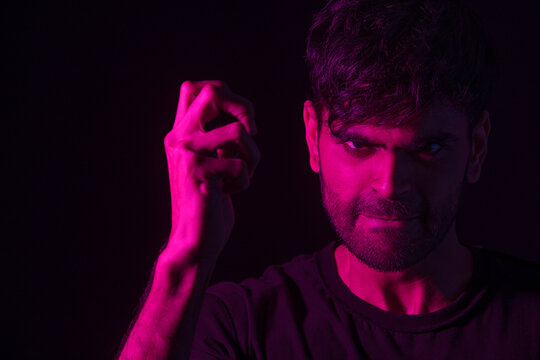 portrait of an angry man with clenched teeth in red