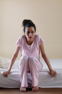 Young girl sitting alone in distress
