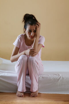 Young girl sitting alone in distress