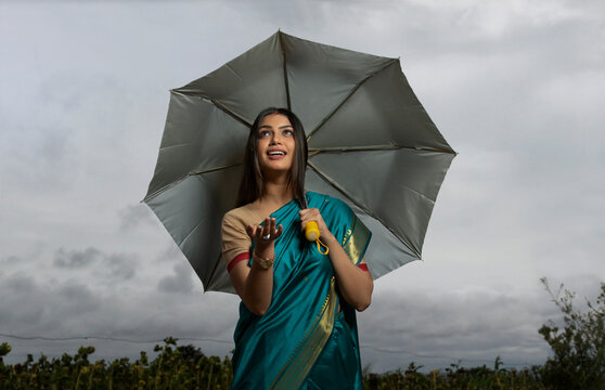 woman standing with an umbrella in her hand 