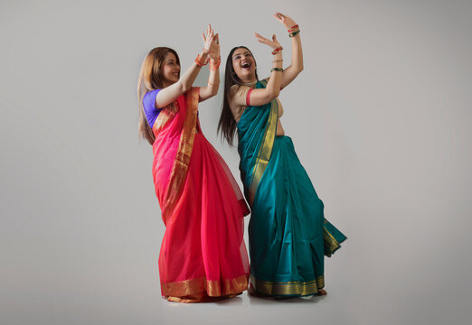 young women dancing in saree