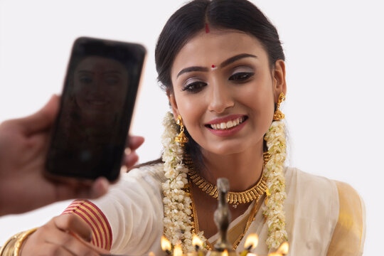 someone clicking picture of a south indian woman