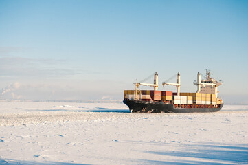 Winter shipping. Cargo ships in frozen ice sea fairway © darkbird