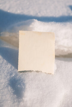 Blank vintage card offers copyspace. Snow background creates seasonal mood