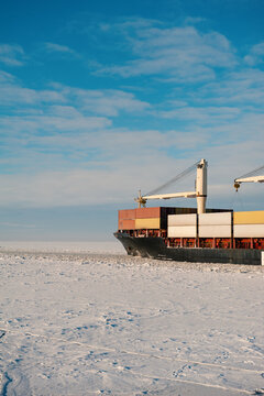 Winter shipping. Cargo ships in frozen ice sea fairway