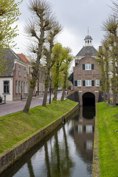 Nieuwpoort historic Waag building and canal with pollarded trees