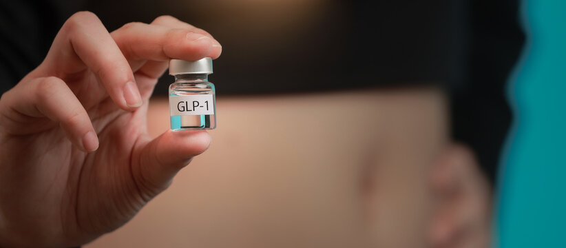 Focused woman holding small medical GLP1 vial for obesity treatment and weight management therapy feeling hopeful for healthy change