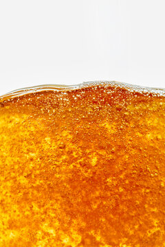 Close-Up of Sparkling Amber Beer Beverage with Bubbles