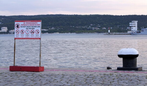 Warning sign on pier at varna port regulating public safety