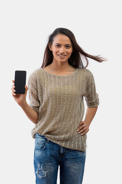 Woman holding mobile phone standing isolated on a white background