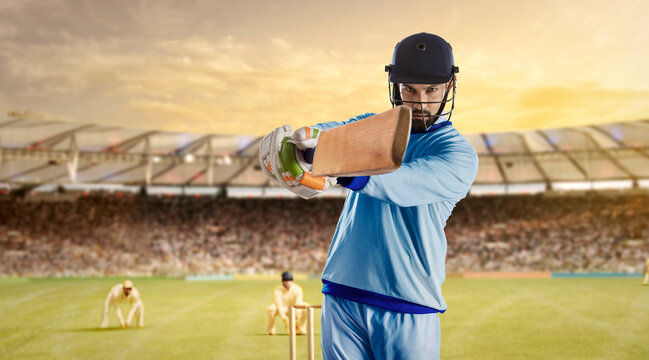 Batsman Hitting The Ball During a Cricket Match In Stadium
