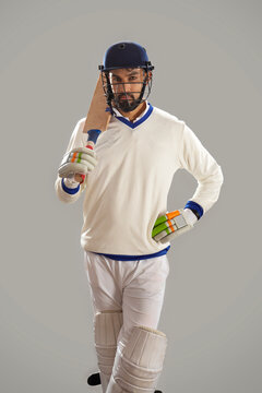 Batsman standing on grey background