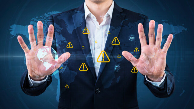 Businessman managing global business risks cyber security threats and system warning alerts on virtual interface