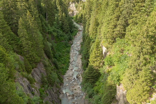 Handegg, Bern, Switzerland. Glacial river winding through forested granite gorge in the Swiss Alps near Grimsel Pass
