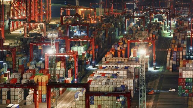 Asia, China, Hong Kong, cityscape time lapse of busy shipping cargo container port, with cranes unloading and loading cargo at night