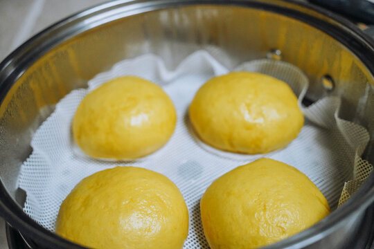 Close up of freshly Steamed Chinese steam Buns in Metal Steamer
