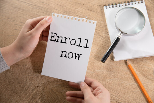 Enroll now text on a white paper