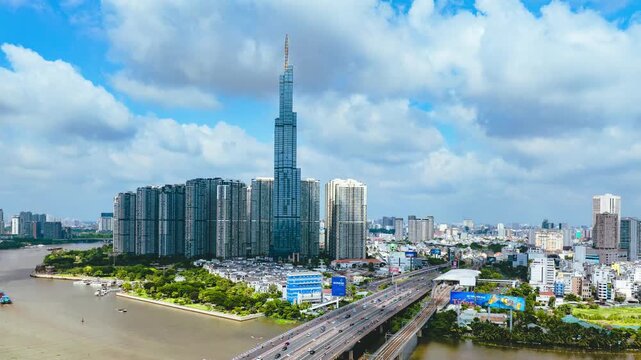 Aerial hyperlapse of Highway Traffic and Modern Skyscraper Skyline in Ho Chi Minh City
dynamic white clouds moving across a vivid blue sky with a massive modern glass skyscraper and urban 