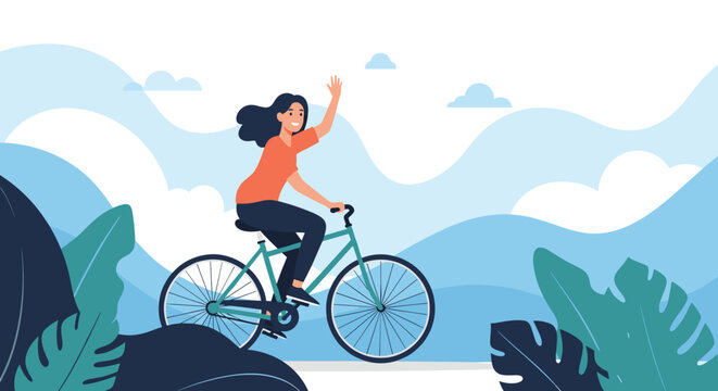 Happy young woman in an orange shirt rides a green bicycle and waves hand against a beautiful mountain landscape.