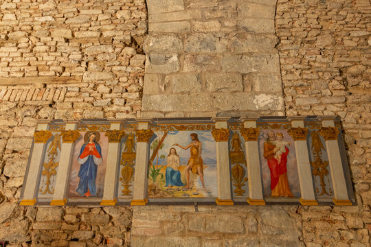 Religious panel depicting The Baptism of Christ, Mary, and Saint Joseph