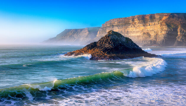 title": "Serene Coastal Landscape with Dramatic Cliffside, Turquoise Waters, and Gentle Waves: A Perfect Blend of Natural Beauty and Tranquility", "description": "This captivating image showcases a b