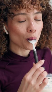 Video of pretty woman eating healthy yogurt bowl at home