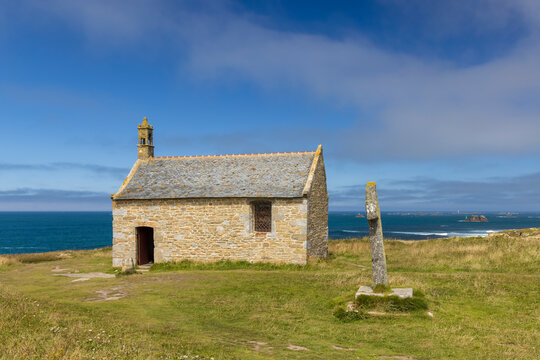 Stone chapel standing by Celtic cross on Landunvez coast