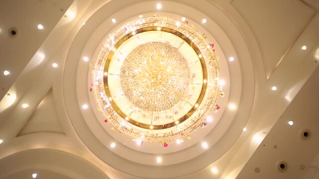 Luxury crystal chandelier in a wedding hall. Elegant ceiling lighting in Delhi NCR venue.