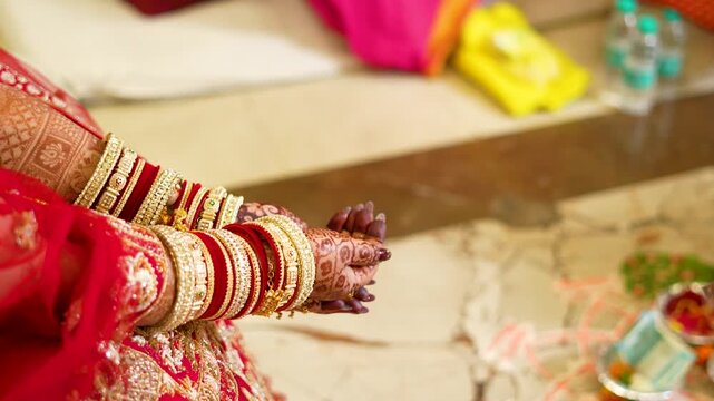 Indian bride hands with henna and bangles. Traditional wedding ceremony in Delhi NCR region.