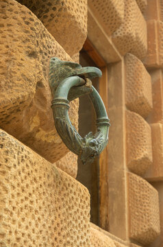 Ancient bronze eagle horse tethering ring on rusticated stone facade of Palace of Charles V in Granada, Spain