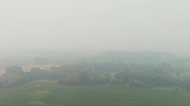 extremely low visibility over large swaths of Wisconsin farmland due to a dangerous uncontrolled wild forest fire smoke in air