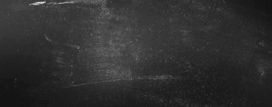 Dark chalkboard texture background with white dust and chalk residue, school blackboard texture, empty space for text, presentation or graphic design.