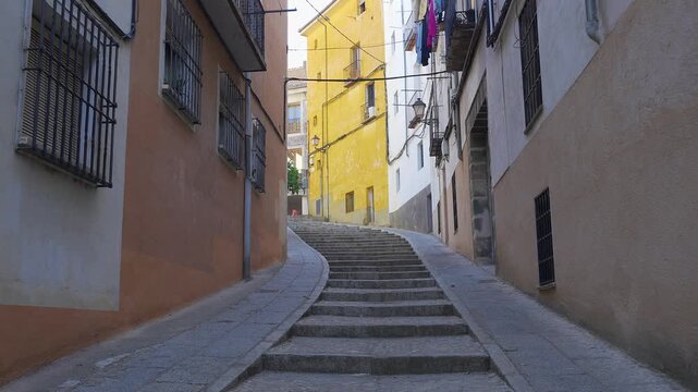 Narrow stepped street lined with colorful facades in the historic San Andres neighborhood of Cuenca