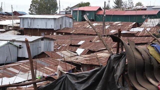 Elevated view of corrugated tin rooftops spanning the dense informal settlement of Kibera, Nairobi, Kenya.