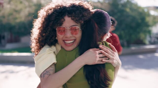 Video of two beautiful women meeting and hugging on the city streets.