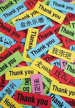 Multilingual Thank You Notes on Colorful Paper Slips Background for Global Gratitude and Appreciation Concept