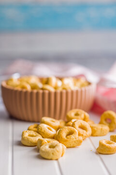 Snack Bowl With Ring-Shaped Savory Crackers On A Light Wooden Table Close-Up Rustic Food Photo