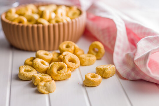 Snack Bowl With Ring-Shaped Savory Crackers On A Light Wooden Table Close-Up Rustic Food Photo