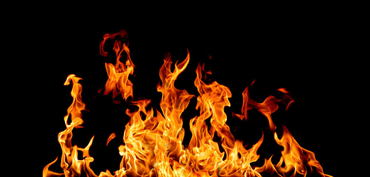 Realistic blazing fire isolated on black background with vivid orange flames, burning heat, inferno, and dramatic flame texture. Perfect fire overlay for VFX, graphic design, advertising.