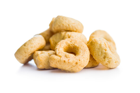 Pile of Golden Italian Taralli Snack Crackers on White Background Close-Up Food Still Life