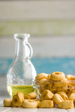 Taralli Italian Crackers With Olive Oil in Bowl On Kitchen Table Rustic Savory Snack