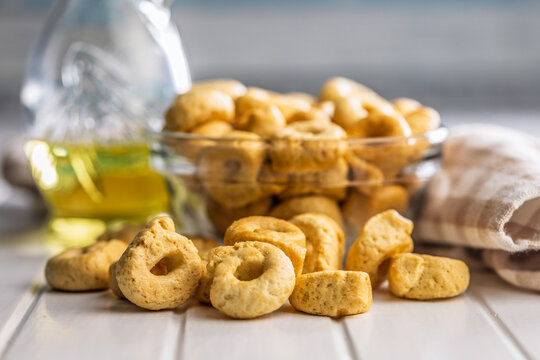 Taralli Italian Crackers With Olive Oil in Bowl On Kitchen Table Rustic Savory Snack