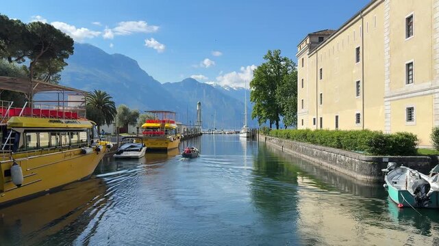 Boats Are Docked Near Rocca di Riva, Medieval Fortress On The Lakeshore Of Riva del Garda In Trentino, Italy. Wide Shot
