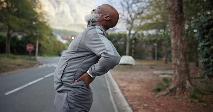 Fitness, man or stretching with back pain outdoor for poor runner form, weak core or sport injury. Cardio, mature black person and spine compression for exercise accident, incorrect technique or ache