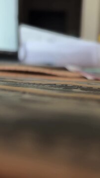 Close-up of US dollar banknotes on a wooden table with shallow depth of field and blurred background. Concept of money, finance, banking.