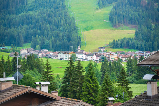Scenic alpine village surrounded by forests in Val di Fassa, Italy