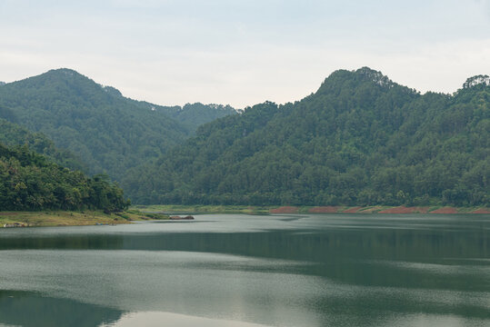 Beautiful panoramic view of Sempor Reservoir surrounded by lush hills in Kebumen, Central Java, Indonesia