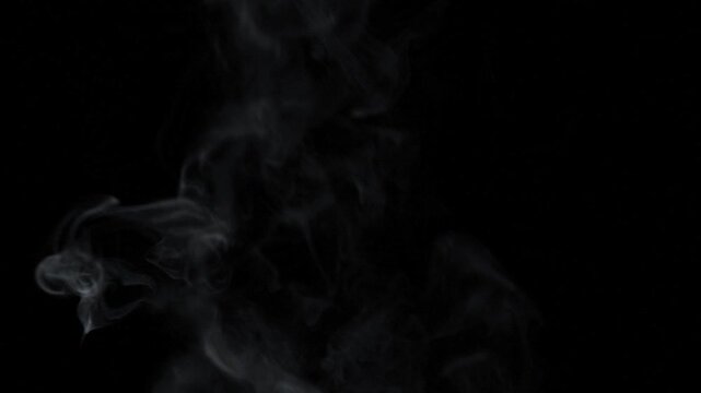 Abstract white steam or smoke rising against black background in static shot
